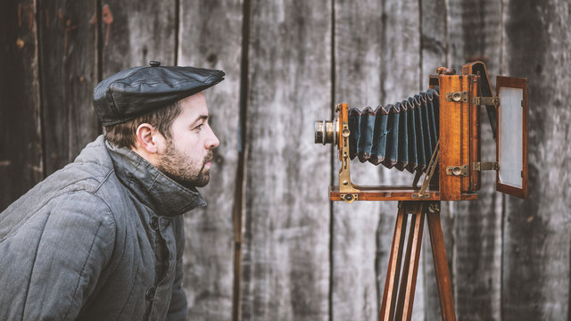 Concept - selfie. Selfie of old fashioned man on large format camera - Powered by Adobe