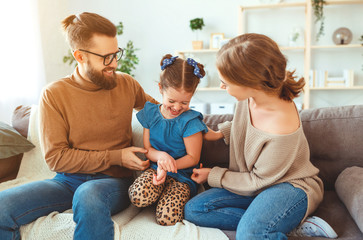happy family mother father and child daughter laughing   at home