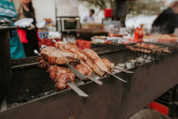 Grilling on the street. Cooking of fish and veal meat.