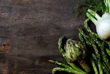 delicacy green vegetables on the background  - asparagus, artichoke, fennel. Useful vegetables, favorite by the French. The concept of detox food and vegetables for gourmes. copy s