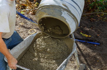 Pouring cement during paving concrete pavement near the house