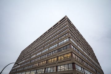 Facade of an old concrete industrial warehouse, office and factory building, north American style,...