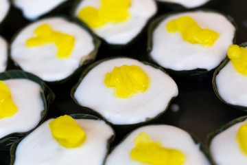 form of pudding.Thai sweetmeat; coconut jelly in a banana cup.gelatin topped with coconut-cream.sweetmeat made of rice-flour with a layer of coconut-milk  Sesame seeds on the top