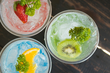 Green Red Blue Italian Soda Cold Beverage and Kiwi Strawberry Lemon Fruit Close Up