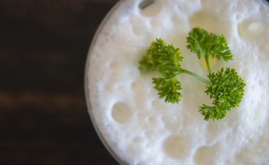 Milk froth and Parsley on Black Flatlay Half