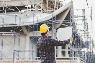 male engineer looking commercial building structure