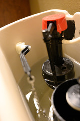 Inside water tank of toilet with float raised