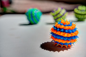 spiked orange and blue striped ball