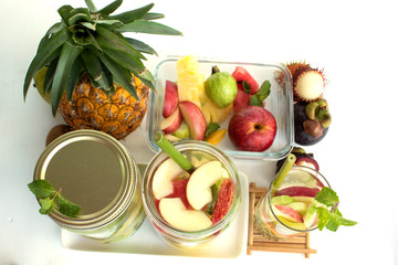 infused water in glass with fruit isolated on white background