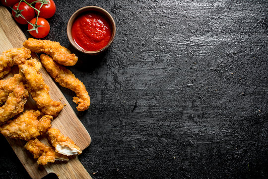 Chicken strips with cherry and tomato sauce.