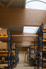 Large wooden trusses support the roof of a large factory building