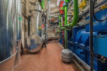 a huge natural gas engine works in a combined heat and power plant and supplies a district with heat