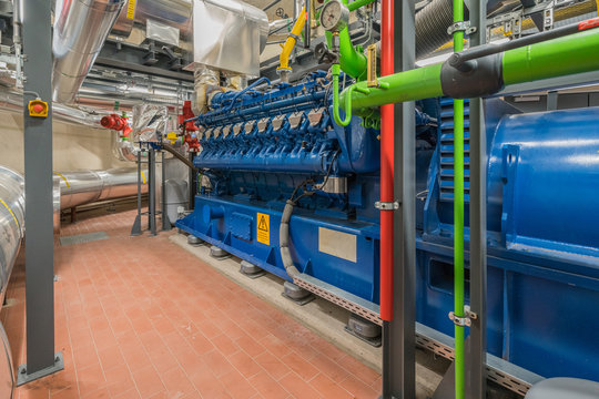 a huge natural gas engine works in a combined heat and power plant and supplies a district with heat