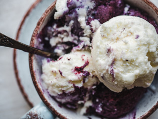 Bright, fruit ice cream on a vintage plate. White, isolated background. Close-up, top view. Concept of tasty and healthy food