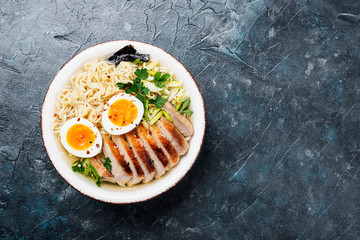 Traditional Japanese soup ramen with meat broth, asian noodles, sliced pork and eggs .  Asian style food. 