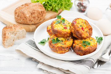 Delicious egg muffins with meat, cheese and vegetables .