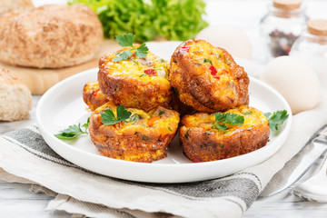 Delicious egg muffins with meat, cheese and vegetables .