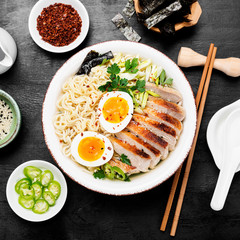 Traditional Japanese soup ramen with meat broth, asian noodles, sliced pork and eggs .  Asian style food. 
