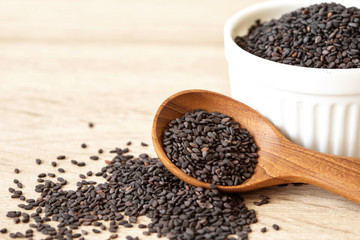 organic a Black  sesame seeds in wooden spoon ,healthy food for reductions in both systolic and...