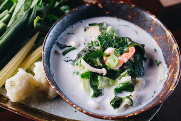 Tao Jiaw Lone (Herb soya beans with minced shrimp and pork in coconut milk served with Fresh Vegetables), Thai food. Top view Photo. 