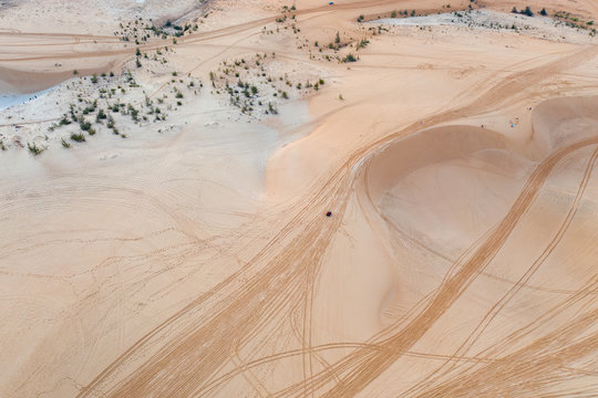 tire trail on the sand - Powered by Adobe