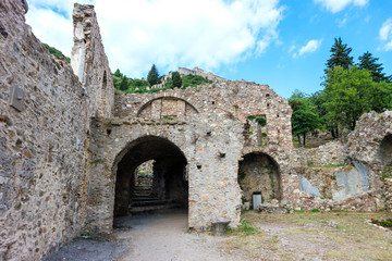 Fototapeta na wymiar Ruins of old medieval monastery in Mystras, Greece against blue sky
