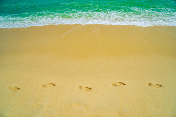 Fototapeta na wymiar Footsteps on the beach