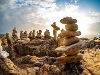 Fototapeta na wymiar Zen stacked stones at the beach