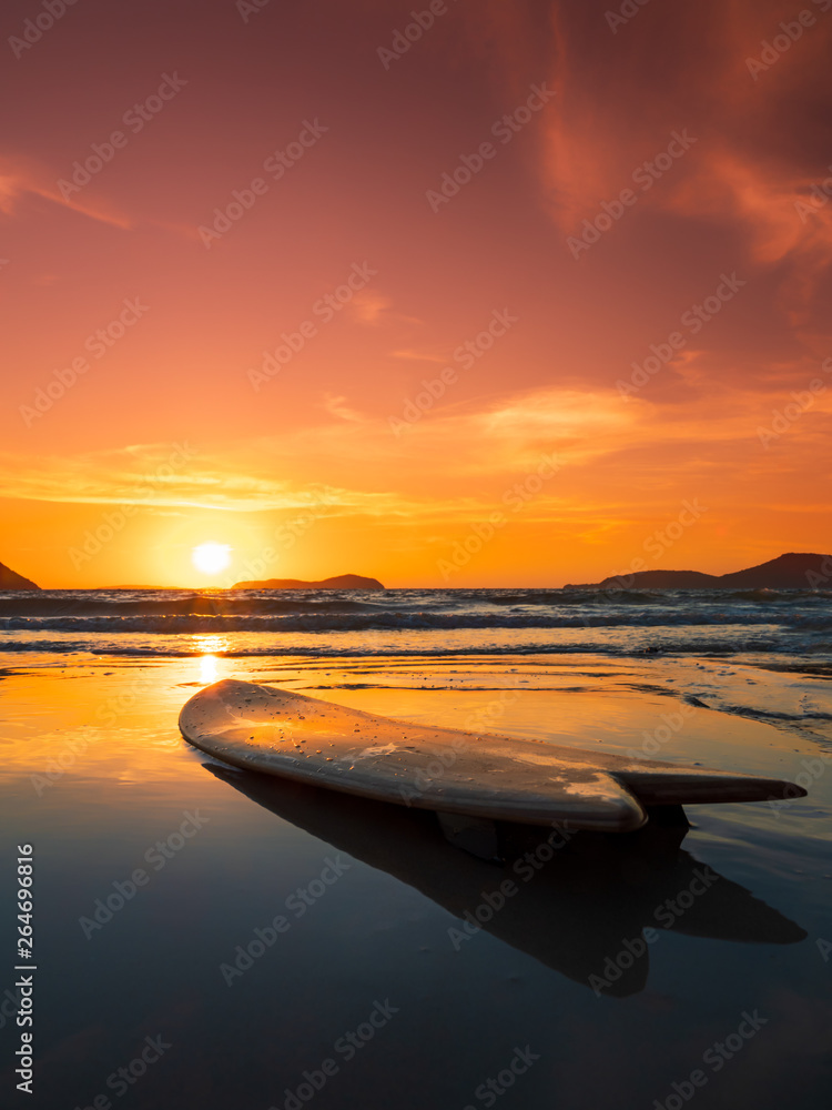 Wall mural surfboard on the beach in sea shore at sunset time - Wall murals
