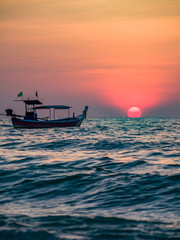 Long tail boat at sunset in Thailand
