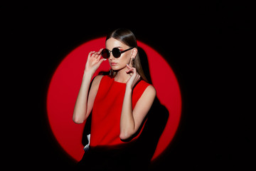 Fashion portrait of young woman in red dress.