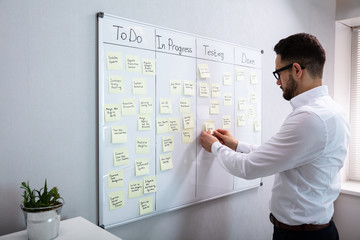 Businessman Writing On Sticky Notes