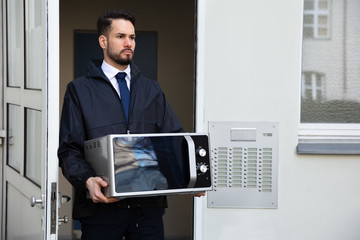 Technician Holding Microwave