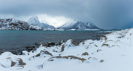 Fototapeta na wymiar Panorama of classic landscape in Lofoten Islands Norway. Beach covered in snow
