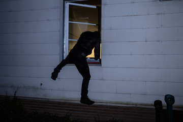 Burglar Entering In A House Through A Window