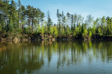 Fototapeta na wymiar Reflection trees in water on swamped quarry, Czech republic