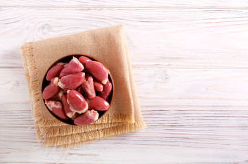 Raw chicken hearts in wooden