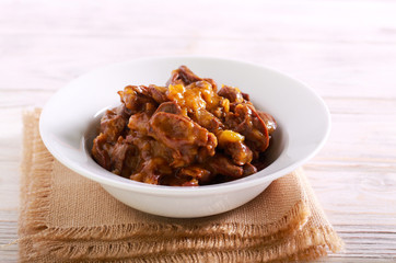 Cooked chicken hearts with gravy