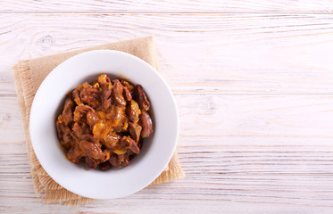 Cooked chicken hearts with gravy