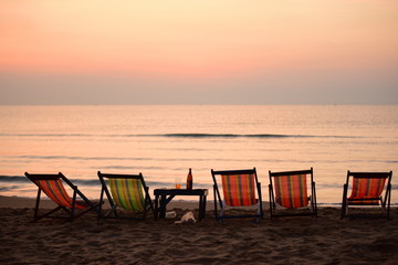 Early morning beach views With a lounge chair When the sun is rising Beautiful golden yellow sky and sun