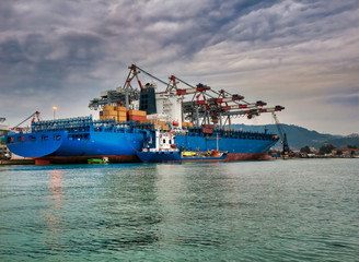 blue container ship in a harbour