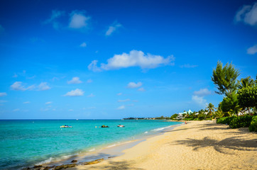 Sunny day on idyllic Seven Mile Beach on Grand Cayman island in the Caribbean.