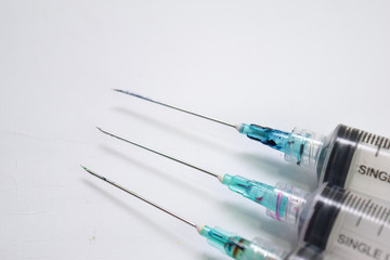 Close up of a syringe selective focus on needle, isolated on white background