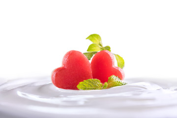Plain yogurt with fresh heart shape watermelon on top in bowl isolated on white background