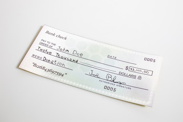 A bank check for donation isolated in a white background