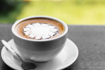 Cup of hot coffee latte on a wooden table natural beauty.