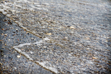 Sea tide. Shore with stone coating. Wave at sea. Background and texture.