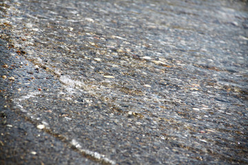 Sea tide. Shore with stone coating. Wave at sea. Background and texture.