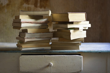 old books used and consumed on a table