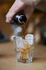 glass of coffee cold brew and ice on wooden table